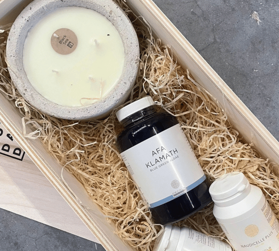 Custom corporate gift box filled with a Mon Dada candle, and personal gifts from the client's company.