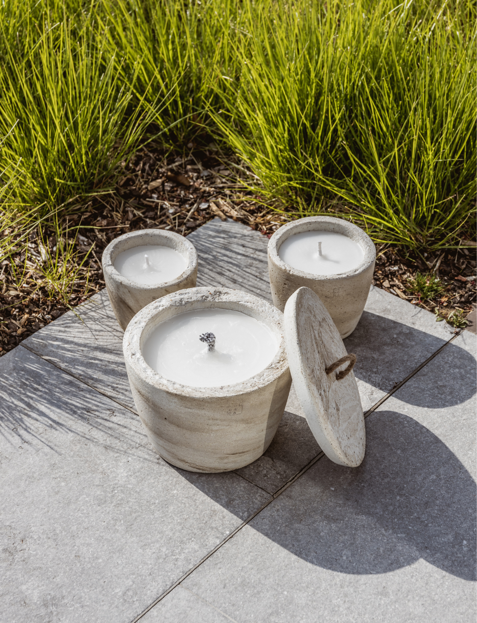 Set of 3 outdoor candles that are handmade in concrete, and manufactured in Waregem.