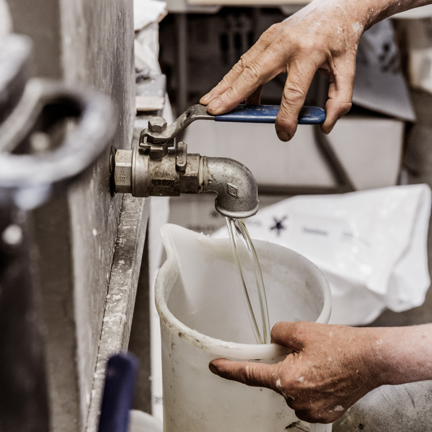 Filling a jug with plant-based, toxic-free coconut and soy wax.