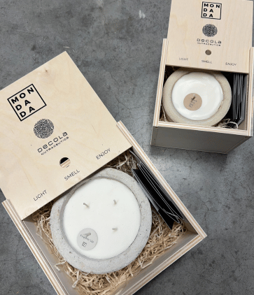 Personalised corporate gift boxes, with personalised logo of the client's brand. In the boxes are handmade concrete candles.