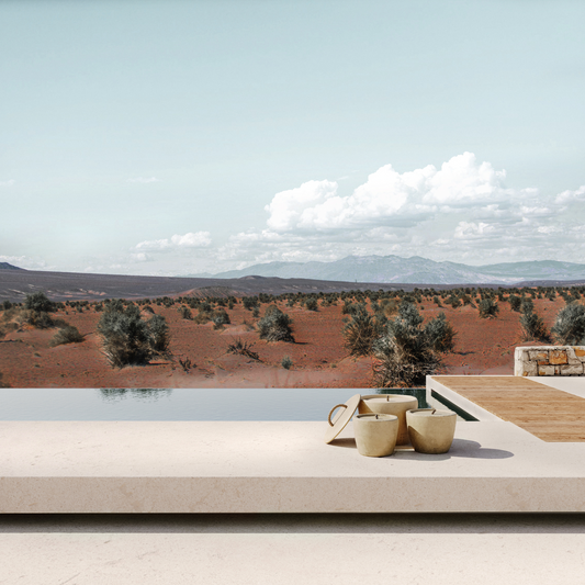 A swimming pool, with a set of handmade concrete candles in front of it. It’s a set of three different sizes, the biggest one has a lid.