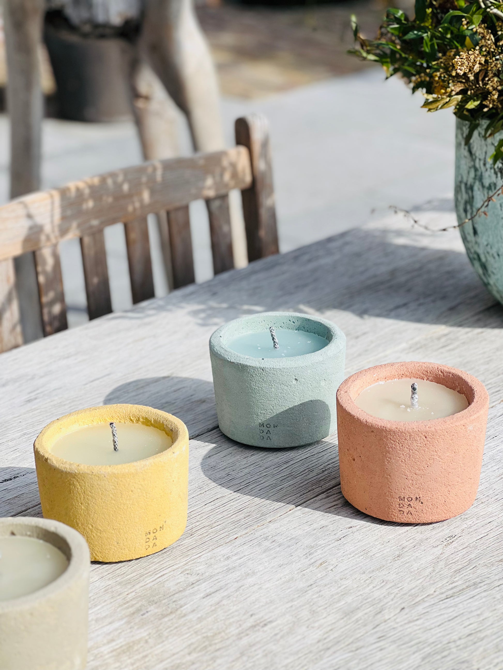 concrete table candles in beige, yellow, blue and red