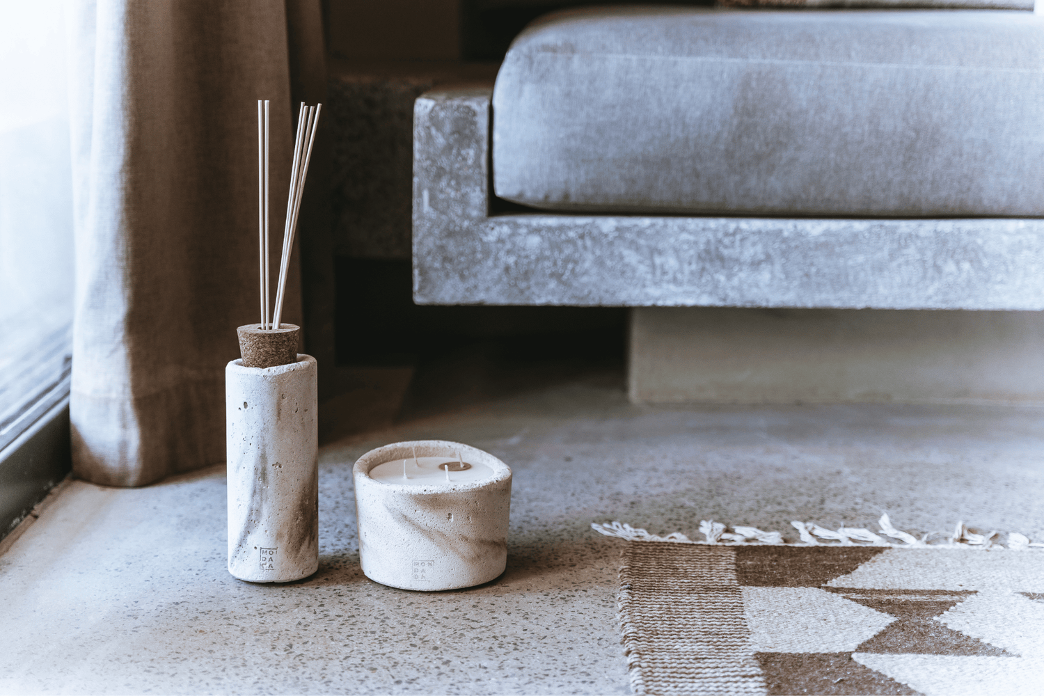 a concrete diffuser and a concrete candle